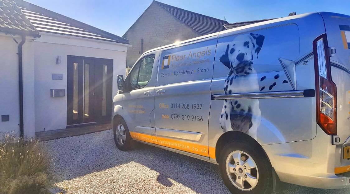 The branded Floor Angels van outside a modern home, with the company's Carpet, Upholstery and Stone specialism wrap visible