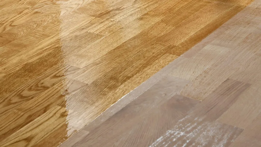 Warm-toned wood floor in a chevron pattern, mid-restoration