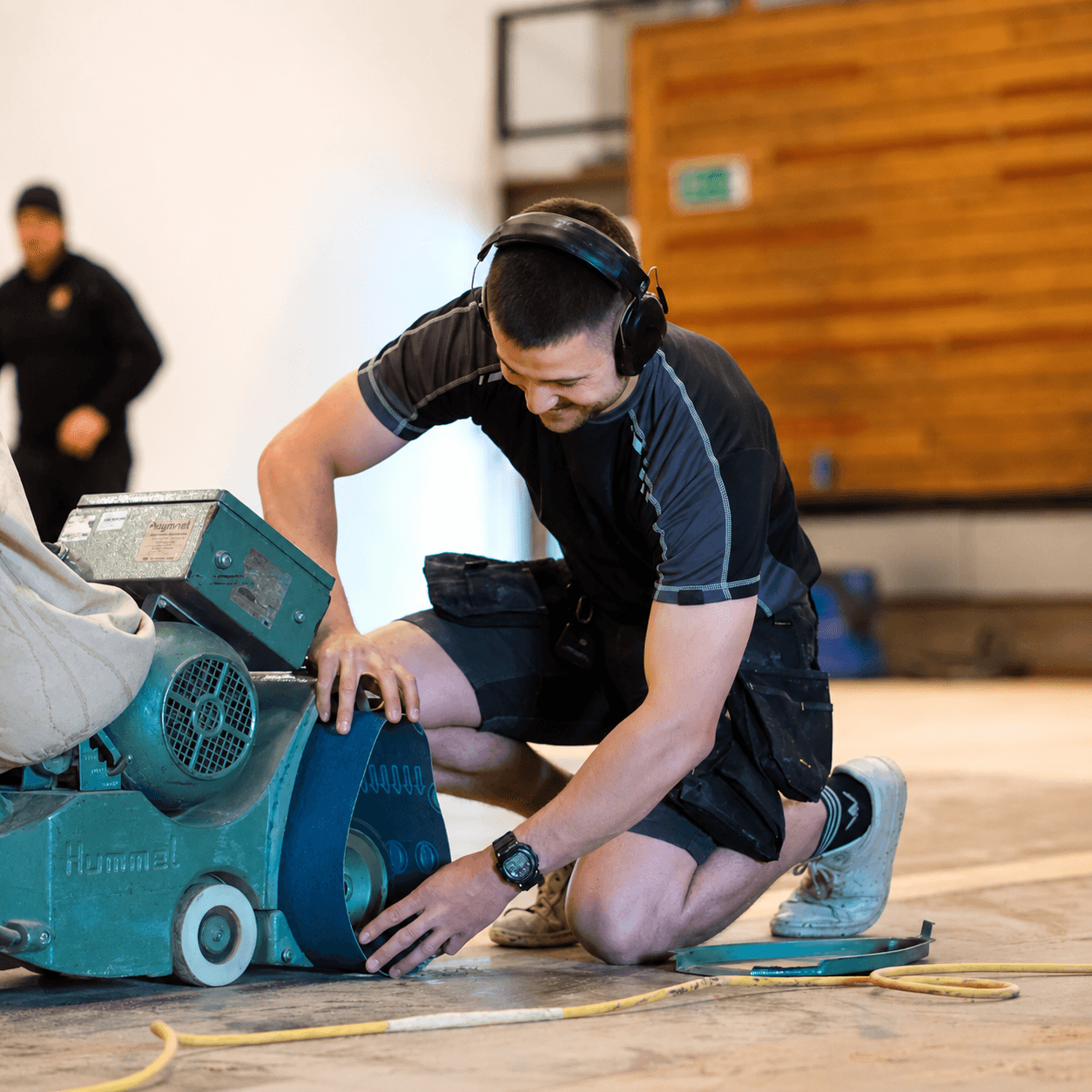Floor Angels craftsman operating a professional floor sanding machine