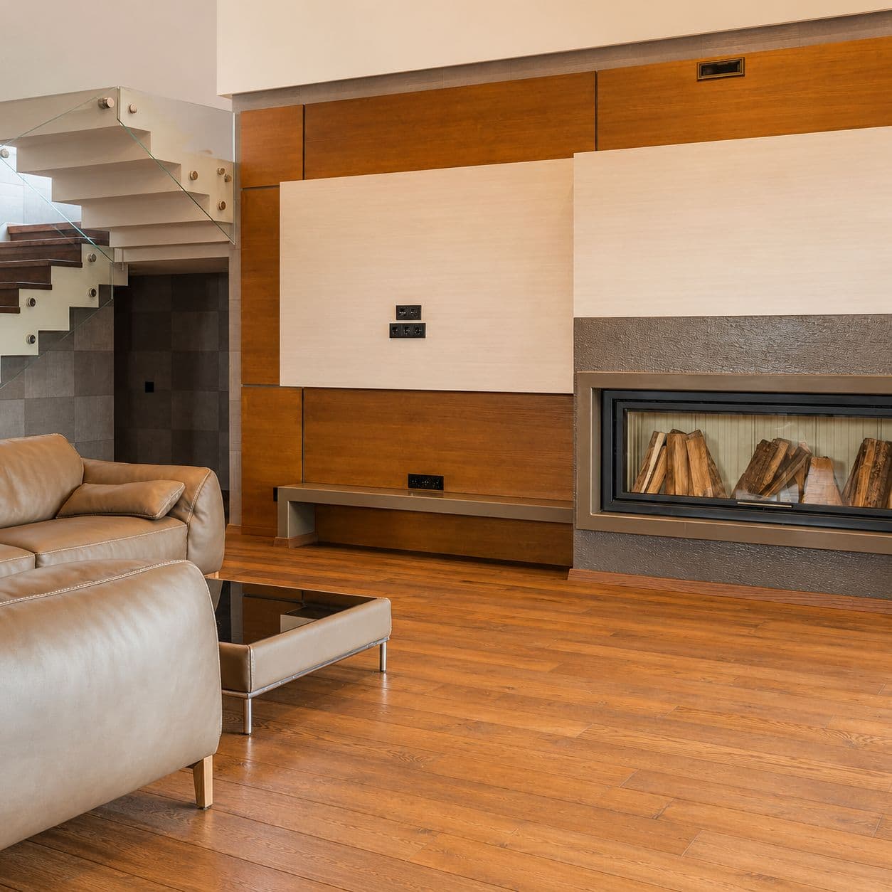 Restored wood floor in an elegant living room with fireplace and contemporary furniture