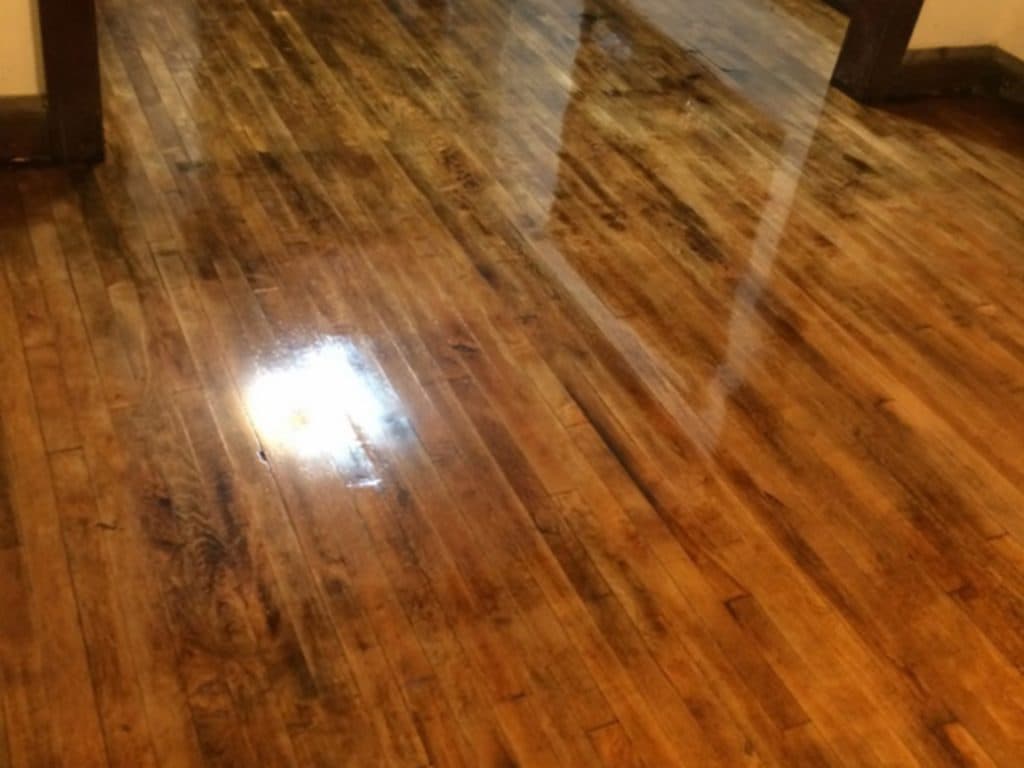 Study desk in a school setting with notebooks, a school bag and a hardwood floor