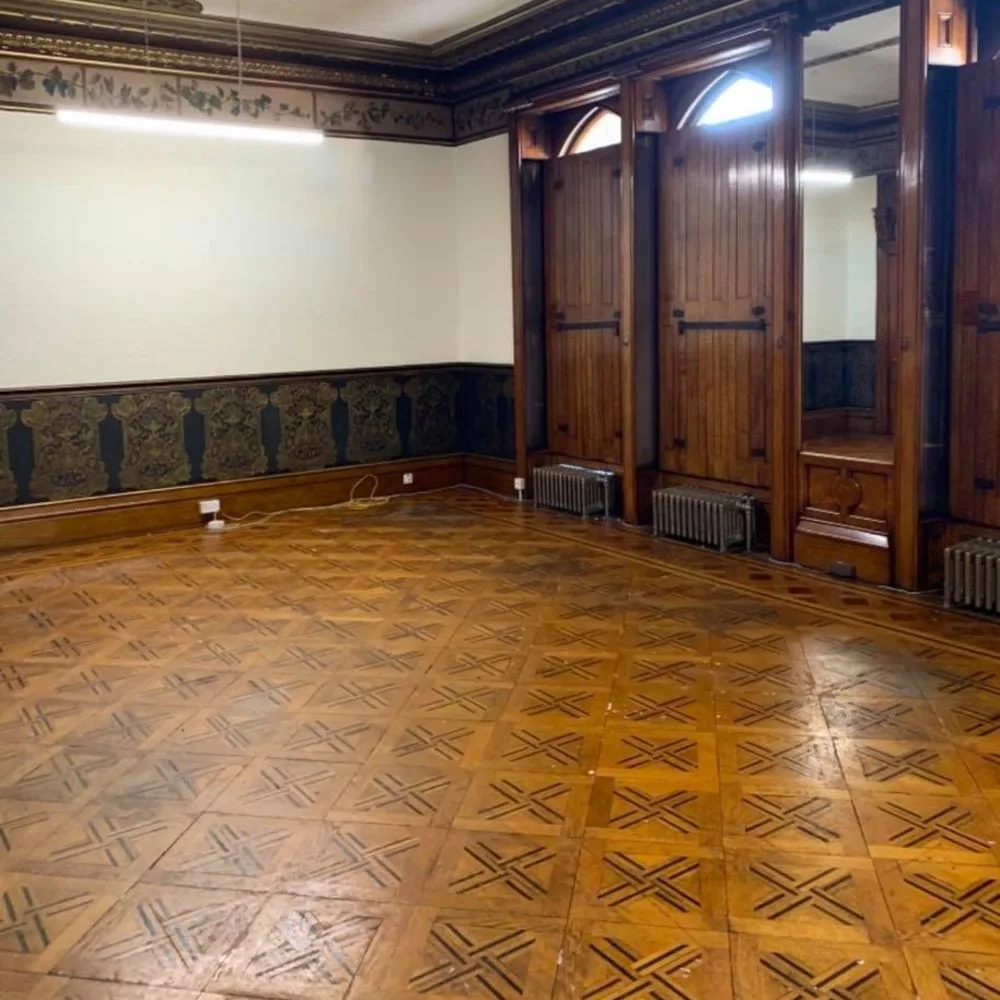 Dust-free sander in operation on a school wood floor with minimal airborne dust