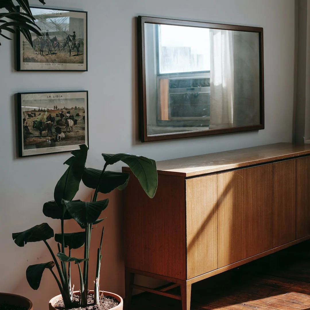 Mid-century sideboard on a restored wood floor with framed art above