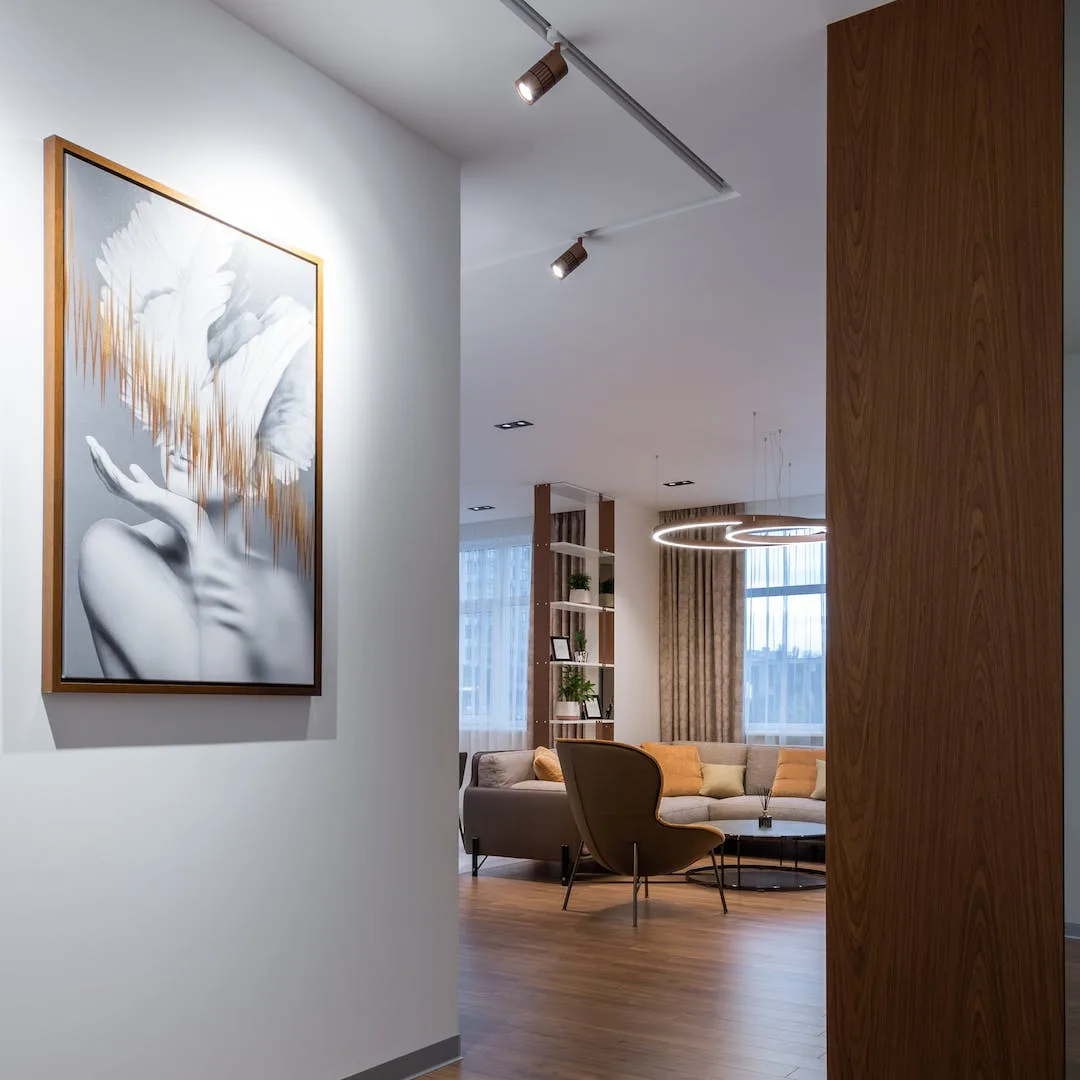 Contemporary living room with track lighting and a restored wood floor