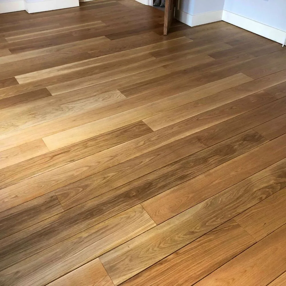 Restored wood floor with sunlight catching the grain in a Sheffield home