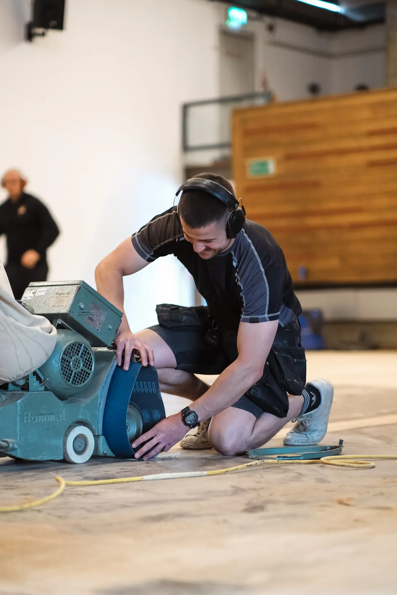 Wood floor restoration training session — hands-on sanding demonstration in a workshop